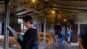 Visitors inside a reconstructed barrack at the Sachsenhausen Concentration Camp