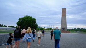 visitors walking towards the Liberation Obelisk at the Sachsenhausen Concentration Camp Memorial